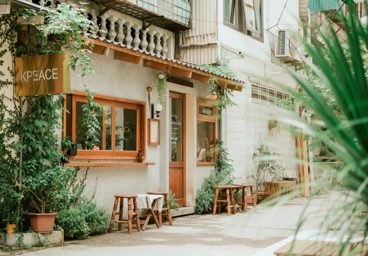 brown wooden chairs and tables outside building during daytime